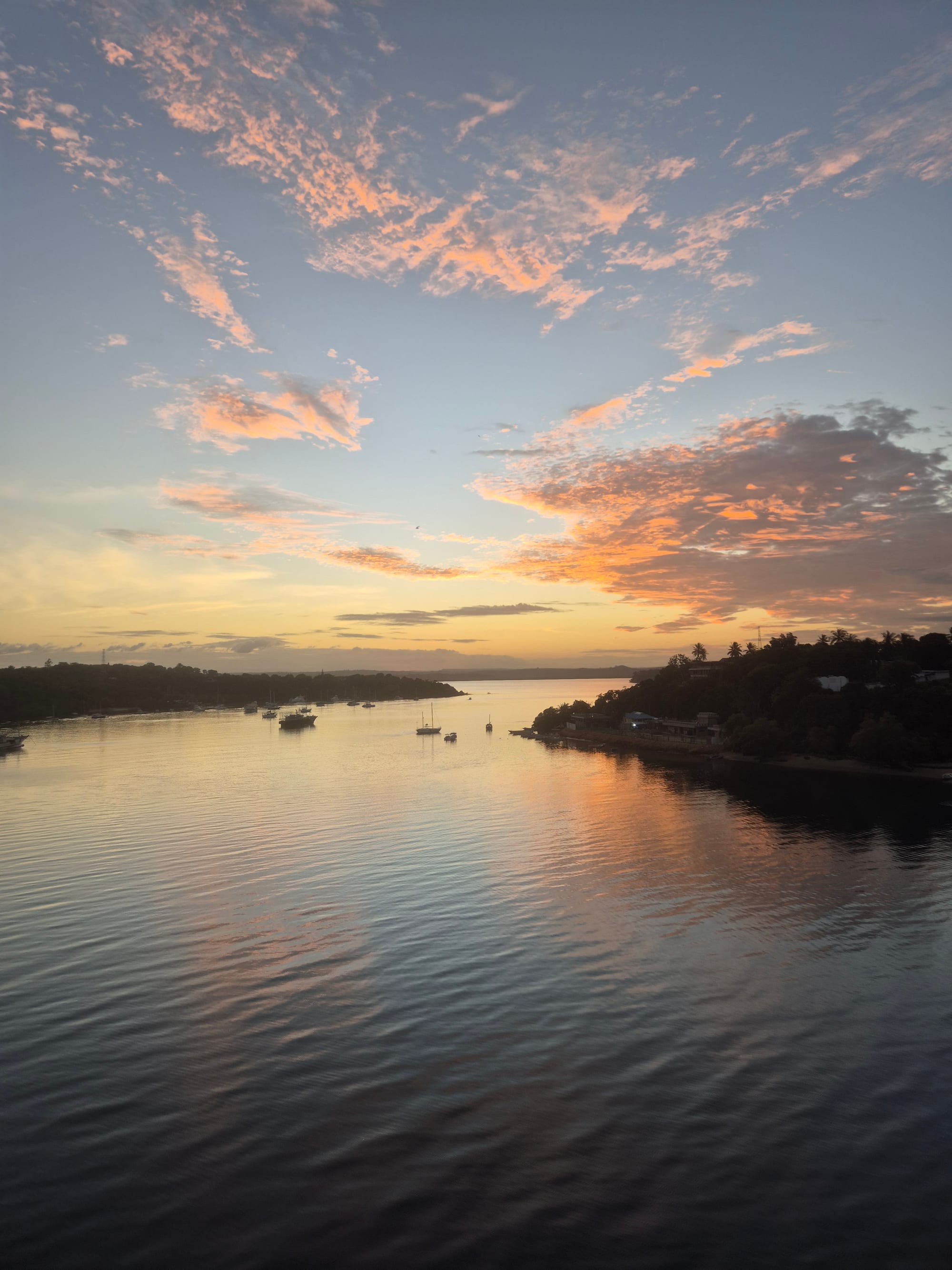 Sunset over Kilifi Creek with boats moored on the water