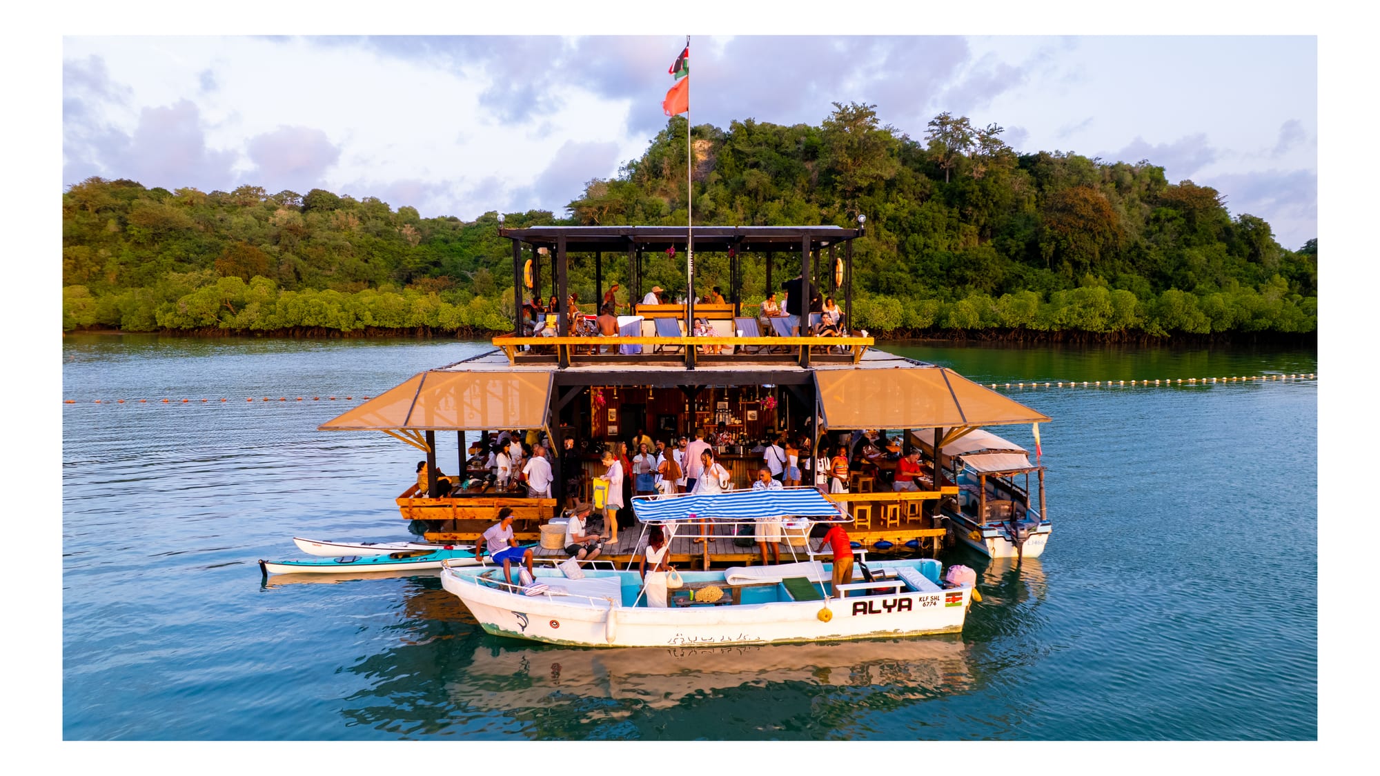 Boats moored at the floating bar at Salty's on the Creek
