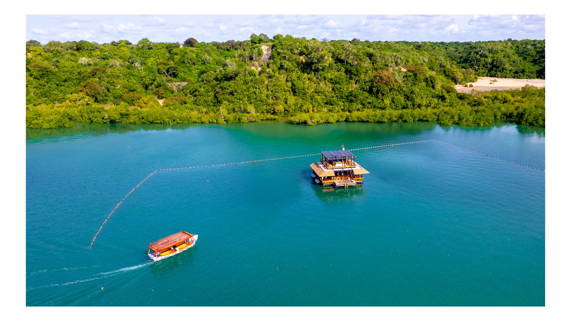 Aerial view of the creek and floating bar at Salty's on the Creek