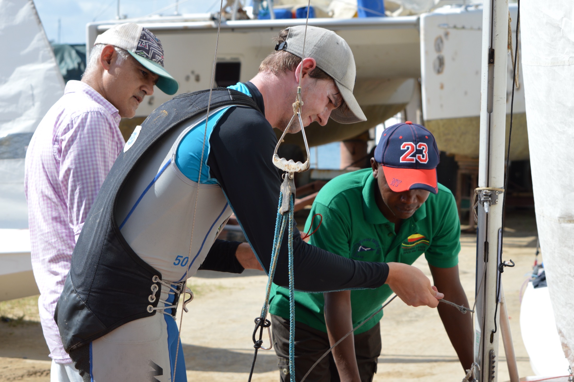 Crew and race officials checking the rig and shrouds before launching